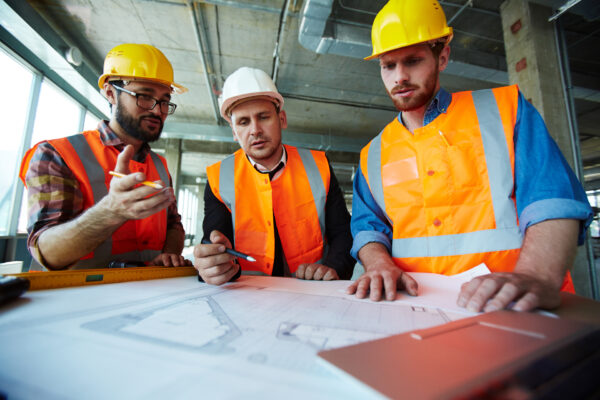 Supervisors discussing sketch of building